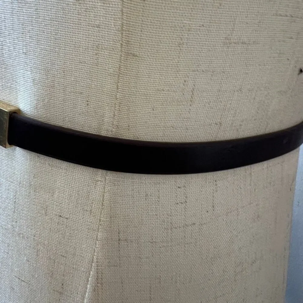 Michael Kors brown skinny belt featuring a polished gold-tone buckle